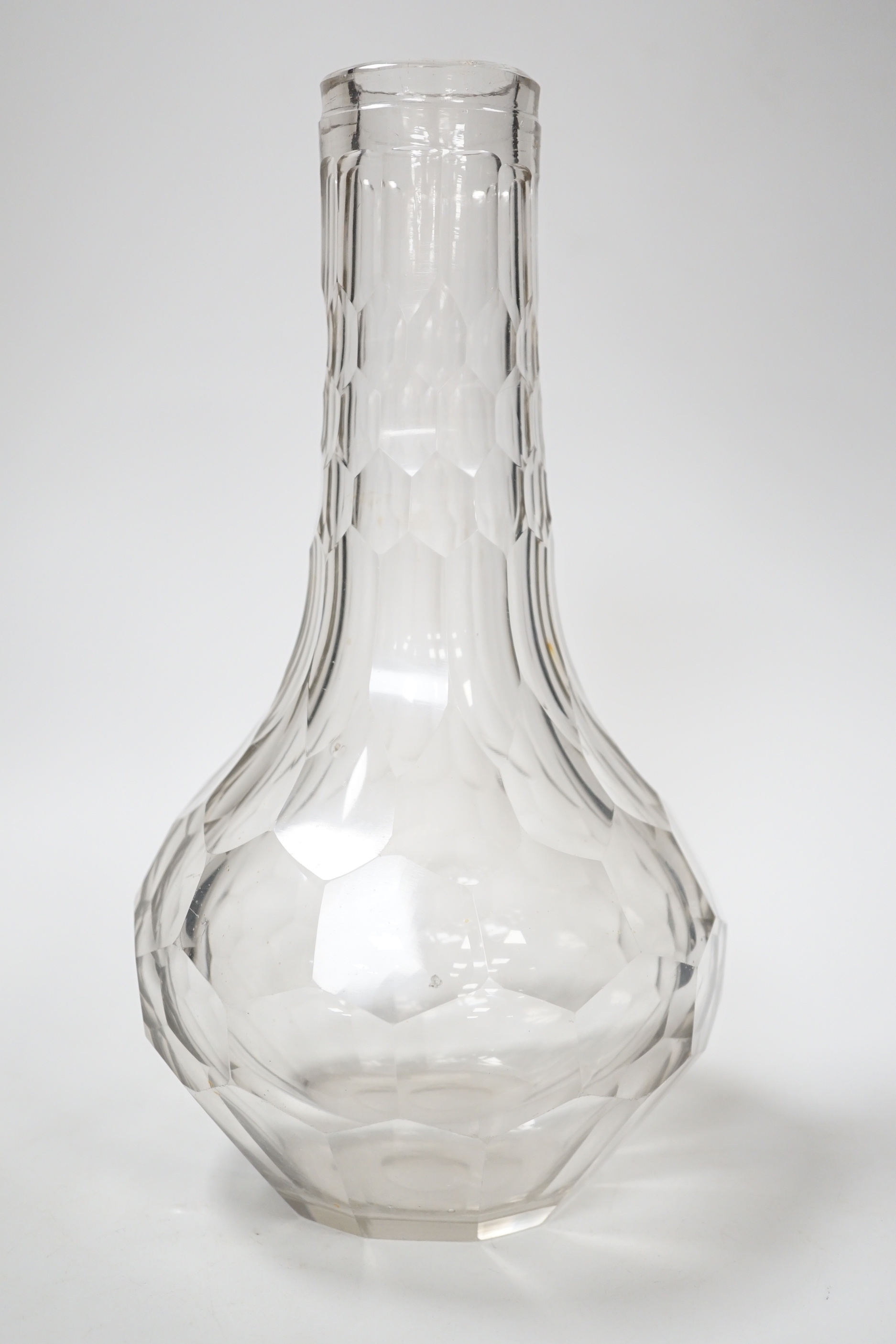 An English lead crystal facetted carafe, 18th century, the whole of the shaft and globe form is decorated with short and long hexagonal facets, the pontil is ground and polished, fine lilac tinge to metal, 28cm high